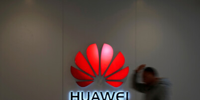 FILE PHOTO: A man walks by a Huawei logo at a shopping mall in Shanghai, China, Dec. 6, 2018. REUTERS/Aly Song/File Photo